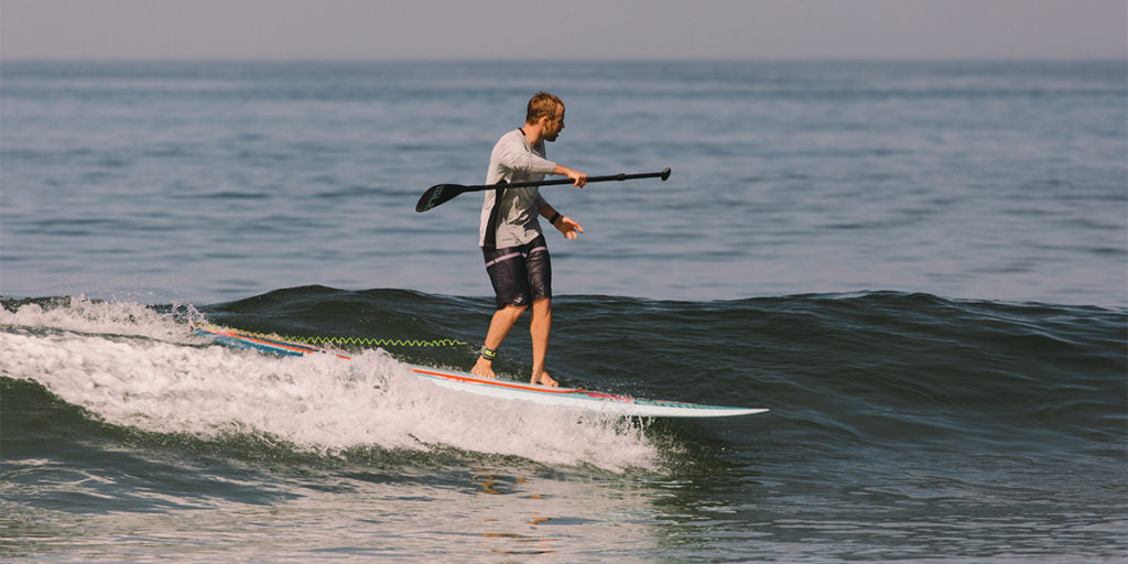 man surfing on a stand up paddle boar