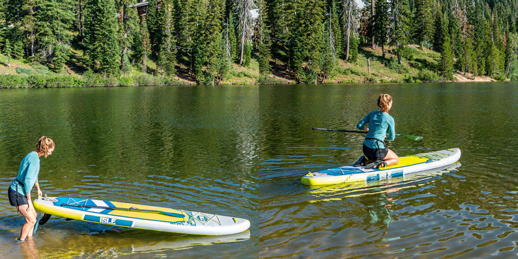 woman entering water on a SUP