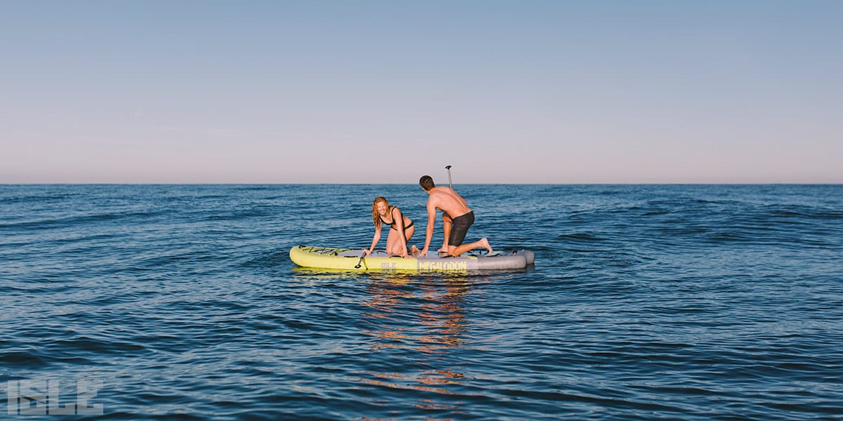 Couple paddle board yoga