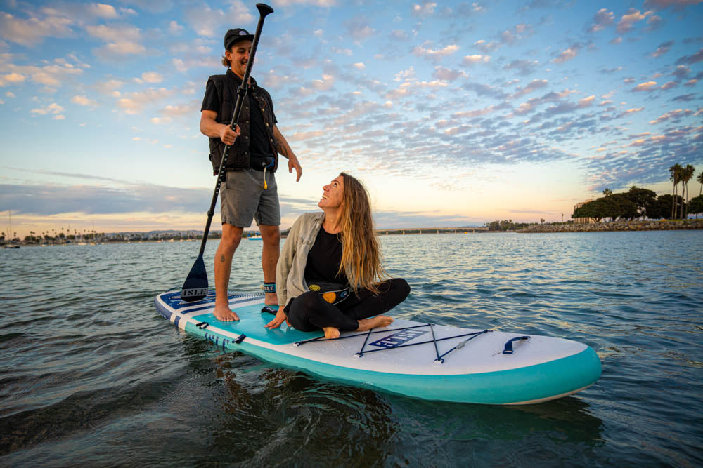 2 people on paddle board sitting