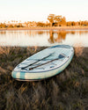 Megalodon Paddle Board In The Grass By The Water