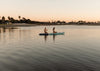 Couple Kneeling On The Megalodon Paddle Board