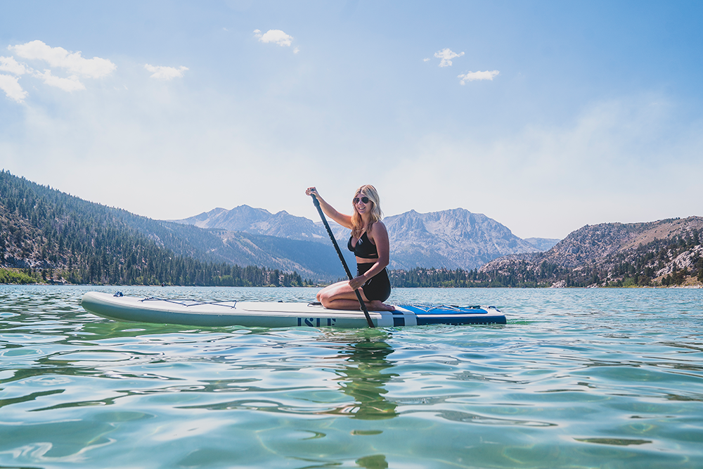 woman sitting on paddle board